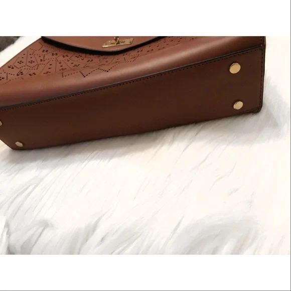 BCBGMaxAzria laser cut trapeze handbag